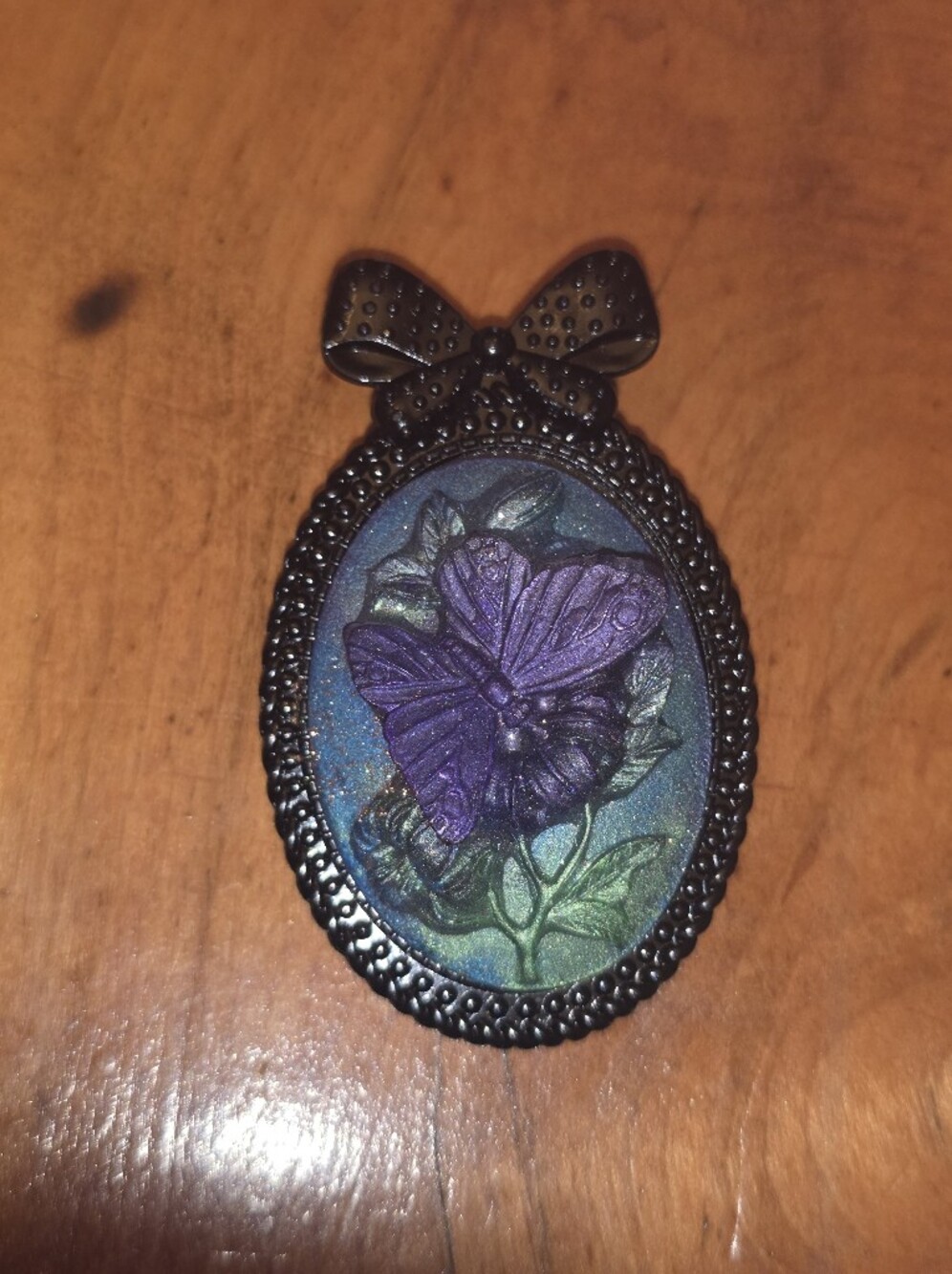 Purple Resin Butterfly Cameo In Black Metal Bow Tie Frame Brooch